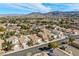 Wide aerial view of the neighborhood showcases a close proximity to scenic mountains and beautiful skies at 254 Camelback Ridge Ave, Henderson, NV 89012