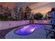 Serene backyard pool illuminated with ambient lighting, perfect for evening relaxation at 254 Camelback Ridge Ave, Henderson, NV 89012