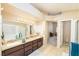 Well-lit bathroom featuring double sink vanity and a bathtub at 254 Camelback Ridge Ave, Henderson, NV 89012
