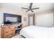 Cozy bedroom with a large TV and ceiling fan at 254 Camelback Ridge Ave, Henderson, NV 89012