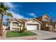 Well-maintained home featuring a two-car garage, front lawn, and desert landscaping at 254 Camelback Ridge Ave, Henderson, NV 89012