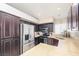 Updated kitchen with stainless steel appliances, granite countertops, and dark cabinetry offering modern functionality at 254 Camelback Ridge Ave, Henderson, NV 89012