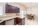 Modern eat-in kitchen with granite countertops, dark wood cabinetry, and a dining area perfect for Gathering gatherings at 254 Camelback Ridge Ave, Henderson, NV 89012