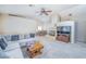 Spacious living room with a fireplace, plush sofa, and seamless flow into the dining area creating an inviting ambiance at 254 Camelback Ridge Ave, Henderson, NV 89012