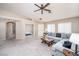 Comfortable living room featuring a plush gray sectional sofa and an open layout flowing into adjacent rooms at 254 Camelback Ridge Ave, Henderson, NV 89012
