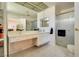 Bright bathroom featuring double sinks, lots of counter space, and a glass-enclosed shower at 2556 Palmera Cir, Las Vegas, NV 89121