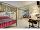 Bedroom featuring bunk beds, carpet, a desk, and a mirrored closet, creating a functional and inviting space at 2556 Palmera Cir, Las Vegas, NV 89121