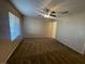 Spacious bedroom featuring soft carpet and natural light with a ceiling fan at 2637 Heathrow St, Las Vegas, NV 89135