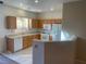 Well-lit kitchen boasts oak cabinets, white appliances, and tile backsplash at 2637 Heathrow St, Las Vegas, NV 89135
