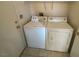 Laundry room with a white washer and dryer and tile flooring at 2637 Heathrow St, Las Vegas, NV 89135