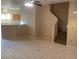 Inviting living room features tile flooring, ceiling fans and stairway to the second floor at 2637 Heathrow St, Las Vegas, NV 89135