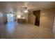 Open concept living room with tile floors, ceiling fans and access to the kitchen at 2637 Heathrow St, Las Vegas, NV 89135