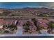 Aerial view of a home in a desert community, complete with desert landscaping, tile roofs and mountain views at 2747 White Sage Dr, Henderson, NV 89052