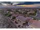 Overhead view of a home featuring a covered patio, manicured yard, and desert landscape with views of the surrounding community at 2747 White Sage Dr, Henderson, NV 89052