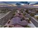 Expansive aerial shot showcasing the neighborhood with tile roofs and desert landscaping against a scenic mountain backdrop at 2747 White Sage Dr, Henderson, NV 89052