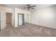Bright bedroom with neutral paint, carpet, closet with mirrored doors, and easy access to the bathroom at 2747 White Sage Dr, Henderson, NV 89052