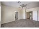 Spacious bedroom with neutral carpet, ceiling fan, and ensuite bathroom access at 2747 White Sage Dr, Henderson, NV 89052