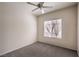 Cozy bedroom featuring neutral paint and carpet and natural light from a large window at 2747 White Sage Dr, Henderson, NV 89052