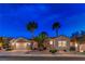 Charming single-story home featuring desert landscaping, a two-car garage, and vibrant palm trees at twilight at 2747 White Sage Dr, Henderson, NV 89052