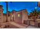 Cozy home exterior showcasing desert landscaping, a tiled roof, and a secure gated entrance for added privacy at 2747 White Sage Dr, Henderson, NV 89052