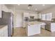 Bright kitchen features stainless steel appliances, granite countertops, and center island at 2747 White Sage Dr, Henderson, NV 89052