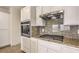 Kitchen features stainless steel appliances, granite countertops, and white cabinetry at 2747 White Sage Dr, Henderson, NV 89052