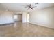 Open living room with neutral walls, tile flooring, and ceiling fan at 2747 White Sage Dr, Henderson, NV 89052