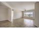 Bright living room with neutral walls, tile flooring, and ceiling fan at 2747 White Sage Dr, Henderson, NV 89052