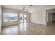 Spacious living room with tile floors, fan, and sliding door to the exterior at 2747 White Sage Dr, Henderson, NV 89052