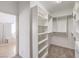 Spacious walk-in closet with built-in shelving and bathroom access, providing ample storage at 2747 White Sage Dr, Henderson, NV 89052