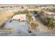 Expansive property featuring a home, RV, boat, mature trees, and desert landscaping, all set against a scenic mountain backdrop at 3051 S Rainbow Ave, Pahrump, NV 89048