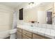 Full bathroom featuring a shower-tub combo and a vanity with a tile countertop and storage cabinet at 3051 S Rainbow Ave, Pahrump, NV 89048