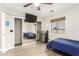 Comfortable bedroom with a ceiling fan, sliding door closet and a large window with natural light at 3051 S Rainbow Ave, Pahrump, NV 89048