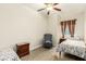 Well-lit bedroom features two twin beds, bedside tables, and a comfortable chair at 3051 S Rainbow Ave, Pahrump, NV 89048