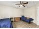 Bedroom with laminate flooring, ceiling fan, and two beds with matching nightstands and dressers at 3051 S Rainbow Ave, Pahrump, NV 89048