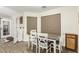 Dining room with a wood table, seating for four, and natural light from the windows at 3051 S Rainbow Ave, Pahrump, NV 89048