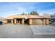 Charming single story home with a large driveway, two-car garage, and desert landscaping at 3051 S Rainbow Ave, Pahrump, NV 89048