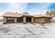 Attractive single-story home featuring a welcoming entrance with columns and desert landscaping at 3051 S Rainbow Ave, Pahrump, NV 89048