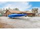 Exterior view of the house, RV parking and blue boat parking on property at 3051 S Rainbow Ave, Pahrump, NV 89048