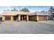 Charming single story home with a large driveway, two-car garage, and desert landscaping at 3051 S Rainbow Ave, Pahrump, NV 89048