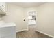 Clean laundry room featuring a washer and dryer, with a view to the kitchen at 3051 S Rainbow Ave, Pahrump, NV 89048