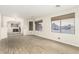 Spacious living room with neutral paint, two expansive windows, and low maintenance flooring at 3051 S Rainbow Ave, Pahrump, NV 89048