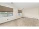 Bright room featuring neutral walls, two large windows, and wood-look flooring at 3051 S Rainbow Ave, Pahrump, NV 89048