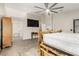 Spacious bedroom with a decorative bed frame, ceiling fan, and ensuite bathroom entrance at 3051 S Rainbow Ave, Pahrump, NV 89048
