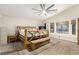 Main bedroom featuring rustic wood furnishings, natural light, and a ceiling fan at 3051 S Rainbow Ave, Pahrump, NV 89048