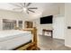 Spacious main bedroom featuring hardwood floors, ceiling fan, and a decorative wood bed frame at 3051 S Rainbow Ave, Pahrump, NV 89048
