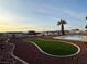 Spacious backyard featuring a putting green, desert landscaping, and community views at 308 Cannes St, Henderson, NV 89015