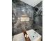 Modern bathroom with a soaking tub and gorgeous dark marble tile and shower niche at 308 Cannes St, Henderson, NV 89015
