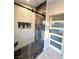 Contemporary bathroom showcases marble-accented walk-in shower, pebble floor, and sliding glass door at 308 Cannes St, Henderson, NV 89015