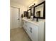 Modern bathroom with double vanity, dark hardware and framed mirrors, offering a luxurious feel at 308 Cannes St, Henderson, NV 89015